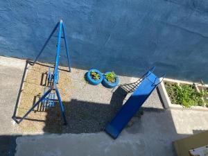 an overhead view of a blue swing set and two plants at Pé na areia apt superior in Itapoa