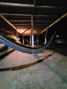 a hammock hanging from a ceiling in a room at Life for Life Hostel Drake Bay Home of Sea Turtle Marine Conservation Project Osa Peninsula near San Josecito Beach in Drake