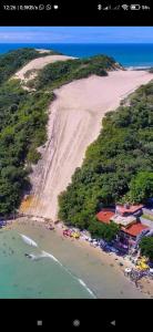 an aerial view of a beach with a large mountain at Pousada Hostel Villa Bella Mar in Natal