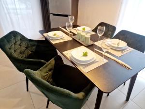 a dining table with plates and wine glasses on it at Modernes Panorama-Domizil in Schömberg