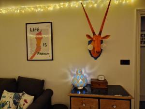 a living room with a antelope head on the wall at Superb Couples Retreat, Quiet & Central Old Town in Hastings