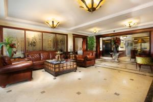 uma grande sala de estar com sofás de couro e uma mesa em TOSCANA INN HOTEL na Cidade do Panamá
