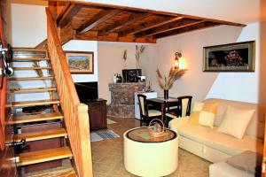 a living room with a couch and a staircase at Shasi Eco Lodge in Ambula