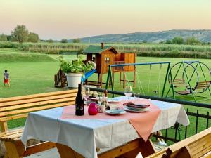 a table with a bottle of wine and a playground at Shasi Eco Lodge in Ambula