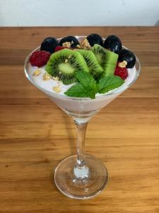 a fruit salad in a martini glass on a table at Port Wine Guesthouse in Calitzdorp