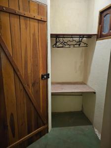 a door leading into a room with a shelf at Canto Verde Pousada in Lençóis