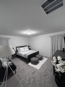 a bedroom with a bed and a couch and a lamp at New, and Modern Home close to the strip in Las Vegas