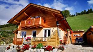 a log home with a porch and a balcony at Chalet Magda in Heiligenblut