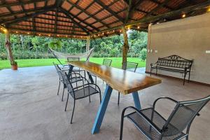 a wooden table and chairs in a patio at Casa Roble Fortuna in Fortuna