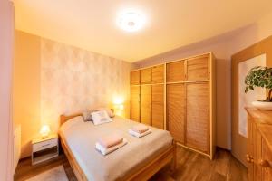 a bedroom with a bed with two towels on it at Center Budget Apartment Inside Free Parking Self Check-In Free Streaming AC Balcony in Budapest