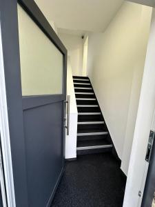 a door leading into a hallway with a staircase at Moparts in Oberhausen
