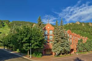 a large red building with trees in front of it at St. Regis Aspen Resort in Aspen