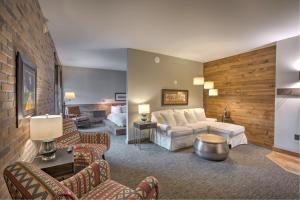 a living room with a couch and a table at Hotel Crosby in Stillwater