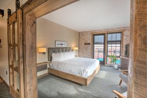 a bedroom with a bed and a large window at Hotel Crosby in Stillwater +55 photos
