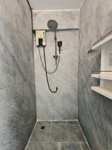 a shower with a shower head in a bathroom at Youyen Hostel in Ban Don Muang (1)