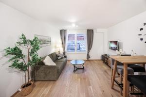 a living room with a couch and a table at Zoder Apartments in Vienna