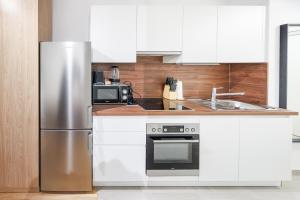 a kitchen with a stainless steel refrigerator and a microwave at Zoder Apartments in Vienna