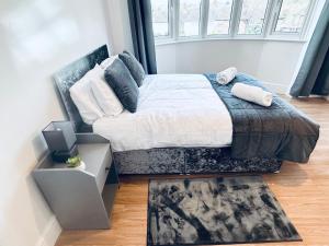 a bedroom with a bed and a large window at Impeccable 3-Bed House in Nottingham Central in Nottingham