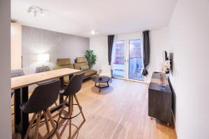 a kitchen and living room with a table and chairs at Zoder Apartments in Vienna