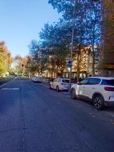 two cars parked on the side of a street at te amo apartamento in Madrid