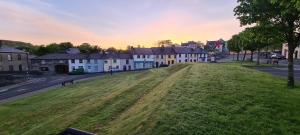 a large grassy field in a town with houses at Central Westport Town House in Westport