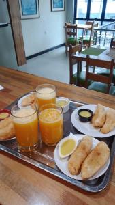 a tray of food with two glasses of orange juice at Casa Nativa Iquitos in Iquitos