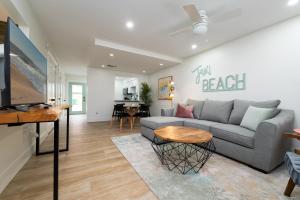 a living room with a couch and a table at Be A Nomad Lovely 2br 1blk from the Ocean in Jacksonville Beach