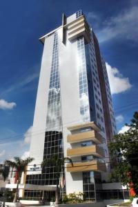 Un grand bâtiment avec beaucoup de fenêtres. dans l'établissement Apto Hotel Blue Tree Manaus, à Manaus