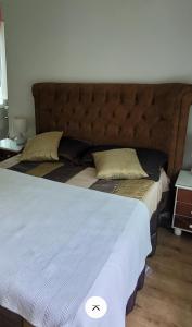 a large bed in a bedroom with a large headboard at Atibaia Racanto Tranquilo in Atibaia +9 photos