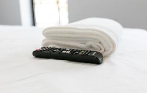a remote control sitting on top of a white towel at Misbau home in Brooklyn