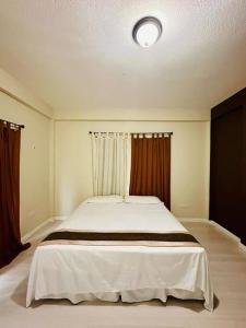a bedroom with a large white bed with curtains at Alto Prado Chocolate in Gwa Kay