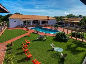 a yard with chairs and a table and a pool at Point Salines Hotel in Gwa Kay