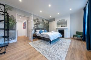a bedroom with a bed and a fireplace at West London Period House in London
