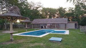 a backyard with a swimming pool and a gazebo at La Yuma en Villars in Villars