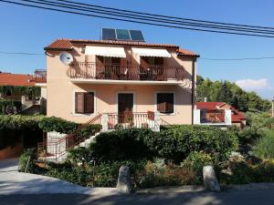 a house with a solar panel on the roof at Apartments with a parking space Vrisnik, Hvar - 8733 in Jelsa