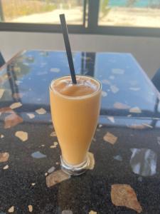a drink in a glass sitting on a table at JCAH BEACH HOUSE free WiFi in Araceli