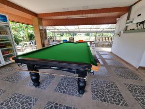 a pool table in the middle of a room at Pool Villa Kiang Na Mae Rim in Mae Rim