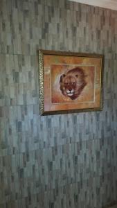 a painting of a cat hanging on a wall at Legacy Guest Lodge in Johannesburg