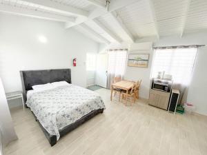 a bedroom with a bed and a table in it at Pedazo del Mar Beach House in Salinas