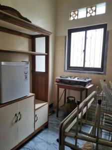 Cette chambre dispose d'une fenêtre, d'un bureau et d'une fenêtre. dans l'établissement Diyan Padhang Homestay Kamar5, à Jetis