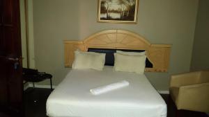 a bed with a piece of paper on top of it at Legacy Guest Lodge in Johannesburg