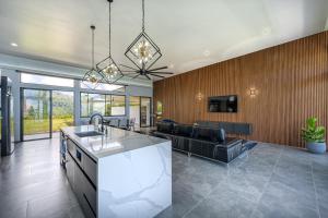 a kitchen and living room with a couch at Brisas Del Mar Hills of Portalón Ocean View in Savegre