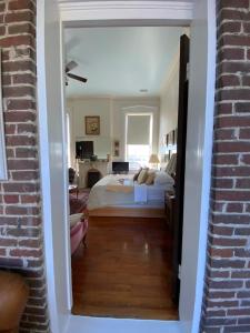 a bedroom with a bed and a brick wall at Bazsinsky House in Vicksburg
