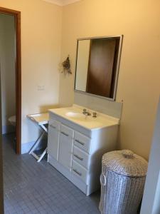 a bathroom with a sink and a mirror at South Pacific in Scotts Head +11 photos
