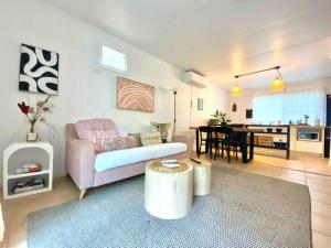 a living room with a couch and a table at Project Tranquility, Magnetic Island in Nelly Bay