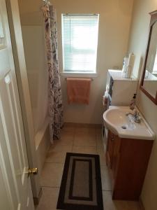 a small bathroom with a sink and a shower at Troy's Place in New Orleans