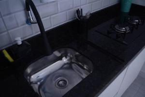 a kitchen sink with a faucet on a counter at Flamengo Home in Rio de Janeiro