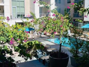 a courtyard with a pool and trees and flowers at The Clouds in Los Angeles