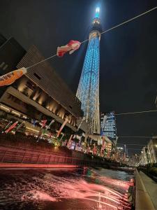 a tall tower at night with a red and blue at SnowHouse in Tokyo