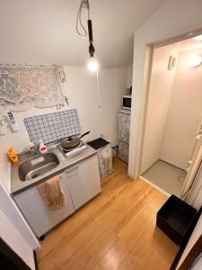 a small kitchen with a sink and a stove at SnowHouse in Tokyo
